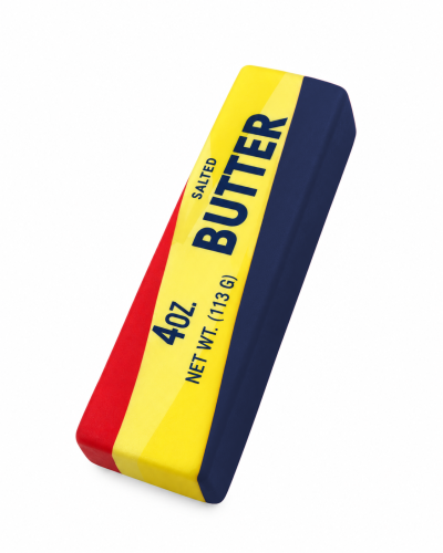 „Butter Squishy w kształcie podłużnego kawałka masła. Powierzchnia w kolorach czerwonym, niebieskim i żółtym z dekoracyjnym nadrukiem. Miękki, piankowy gniotek o zaokrąglonych krawędziach.”